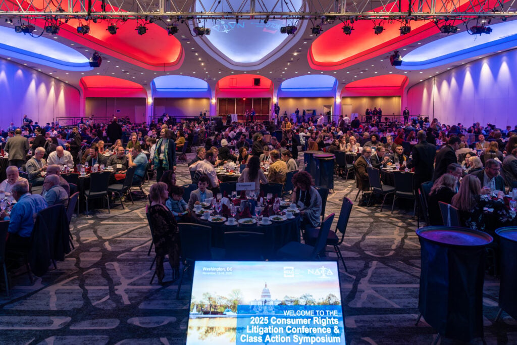Large conference ballroom with attendees seated at round tables during the Consumer Rights Litigation Conference and Class Action Symposium