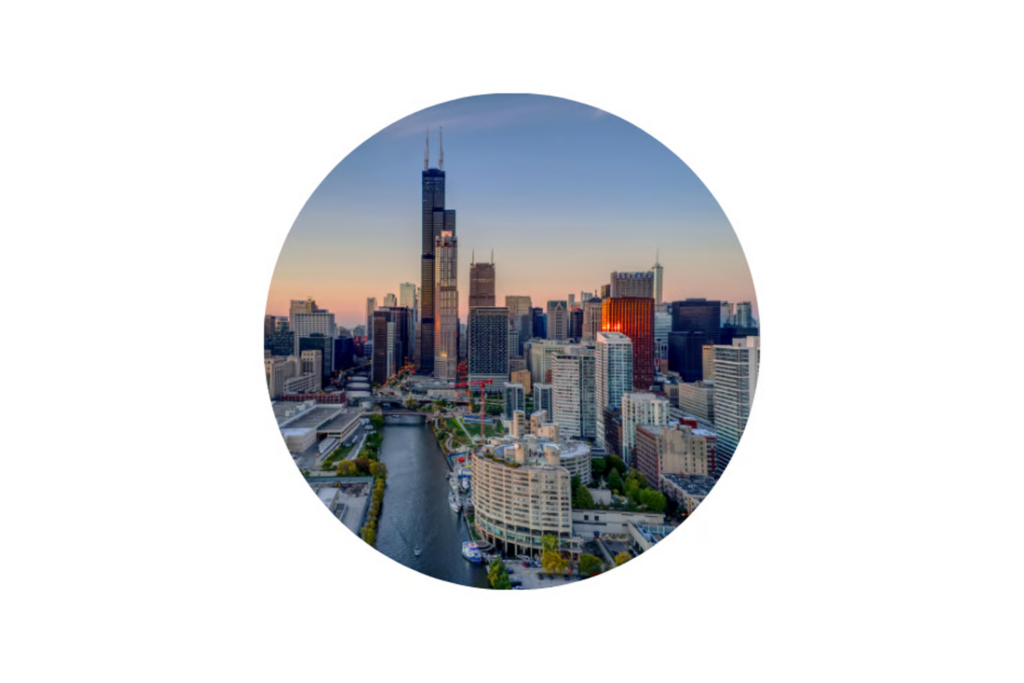 Aerial view of Chicago skyline at sunset with river and skyscrapers in circular frame.