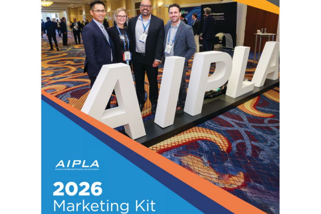 Four attendees posing in front of large AIPLA letter display at a conference hall.